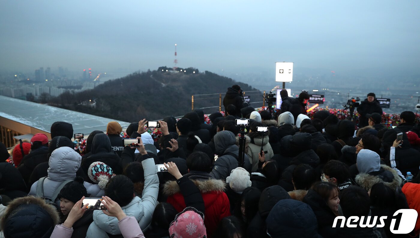 본문 이미지 - 2020년 경자년(庚子年) 새해 첫날인 1일 오전 서울 중구 남산공원을 찾은 시민들이 짙은 구름 너머로 해를 찾고 있다. 2020.1.1/뉴스1 ⓒ News1 민경석 기자