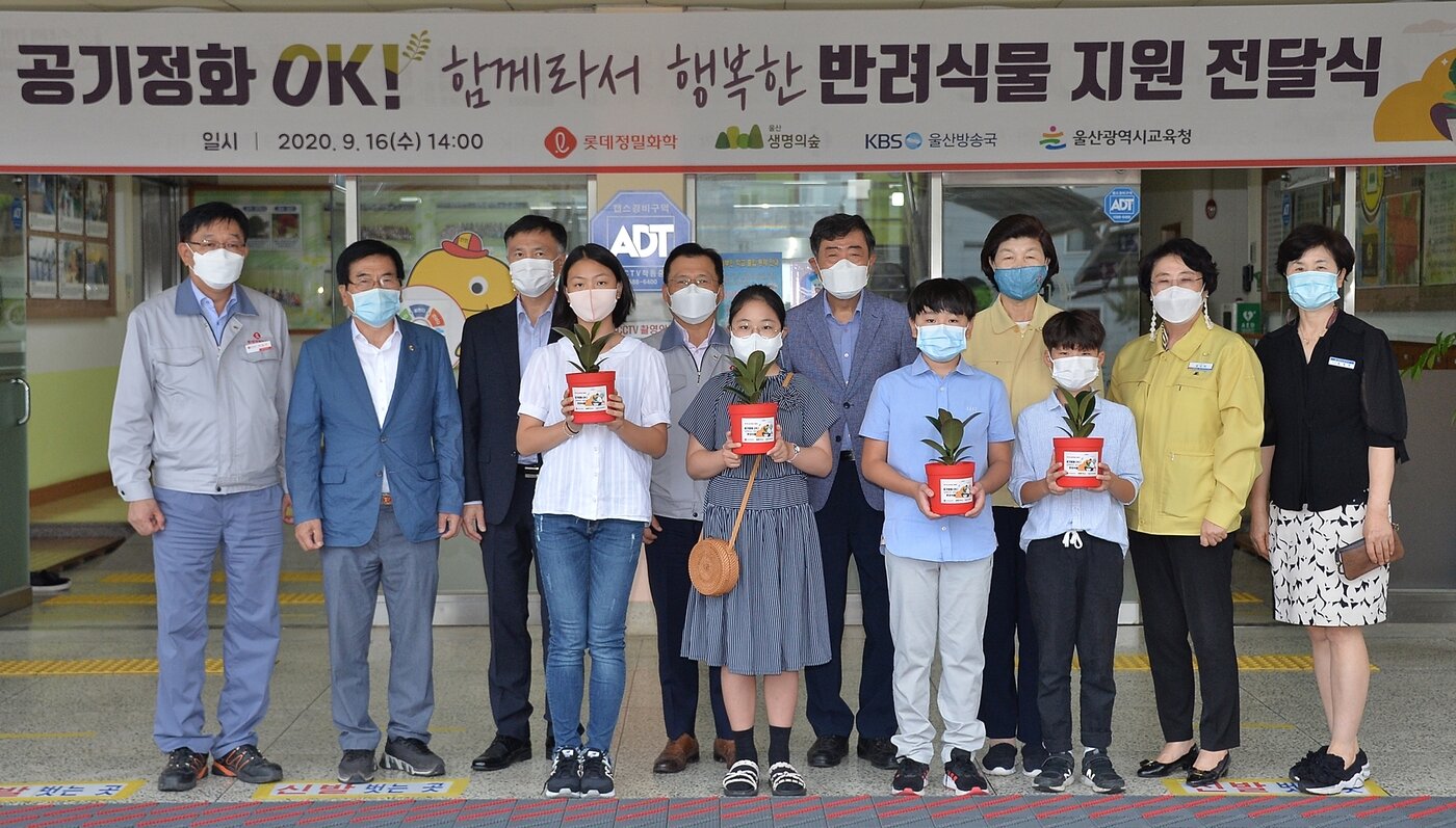 본문 이미지 - 롯데정밀화학 임직원과 울산 월봉초등학교 재학생들이 '제11회 상자텃밭 캠페인'으로 전달된 고무나무 묘목을 들고 기념 촬영을 하고 있다.(롯데지주 제공)ⓒ 뉴스1