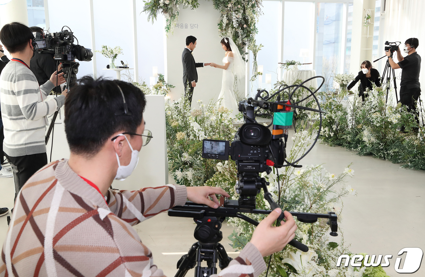 (서울=뉴스1) = KT는 단절된 사회 연결을 위한 비대면 소통 사례로 온라인 라이브 결혼식을 진행했다고 5일 밝혔다. 대구 지역에 친지를 둔 한 예비부부가 4일 강남구 소재 예식 …