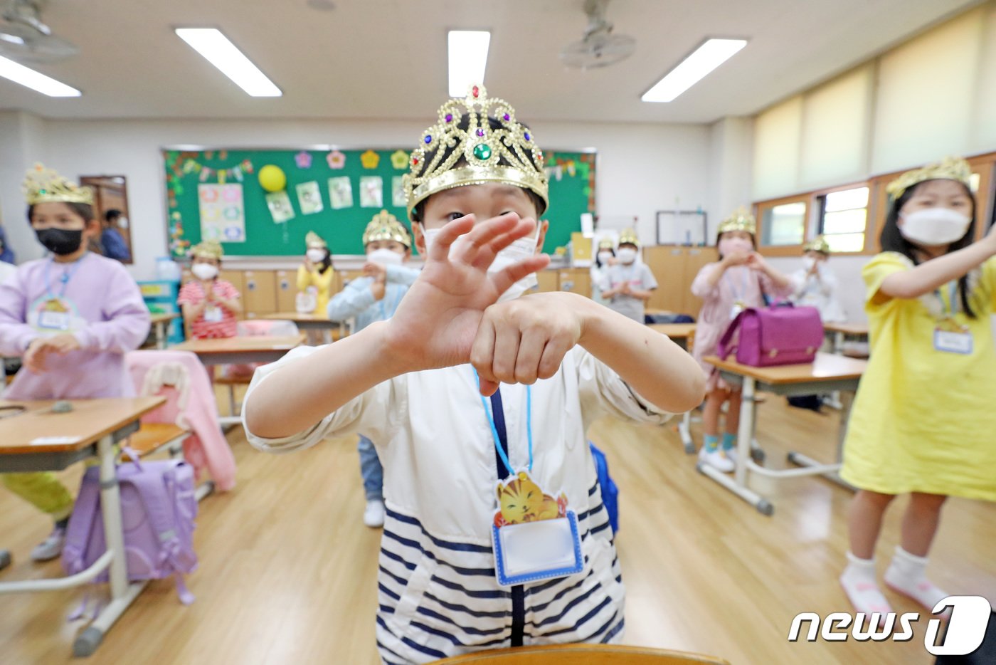 초등학교 1·2학년과 유치원의 등교 수업이 시작된 27일 오후 경기도 수원시 팔달구 매여울초등학교에서 신종 코로나바이러스 감염증&#40;코로나19&#41; 예방을 위해 마스크를 쓴 1학년 학생들이 입학을 축하하는 의미로 왕관을 쓰고 손 씻기 교육을 받고 있다. 2020.5.27/뉴스1 ⓒ News1 조태형 기자