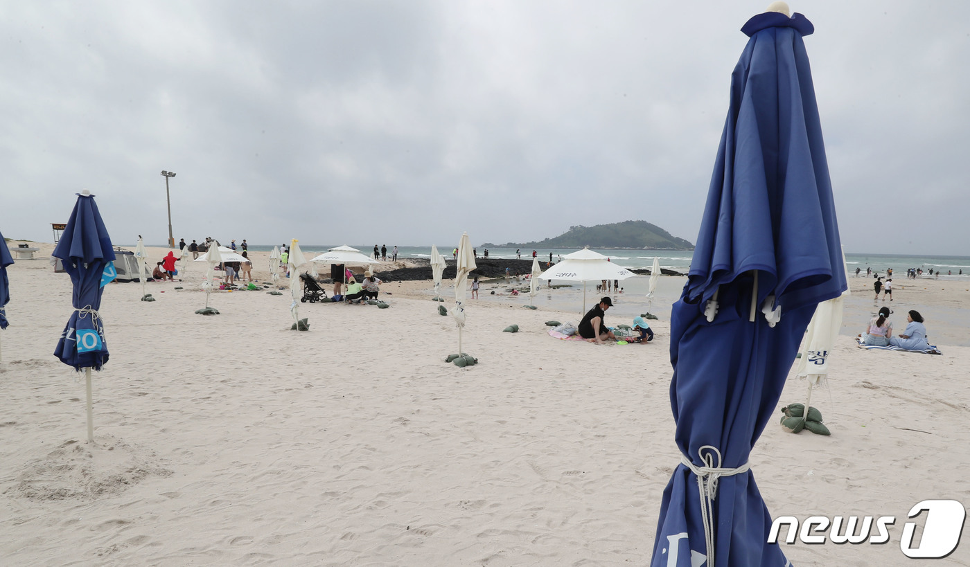 (제주=뉴스1) 오현지 기자 = 해수욕장 개장을 하루 앞둔 30일 오후 제주시 한림읍 협재해수욕장에 2m 간격을 두고 파라솔들이 설치돼 있다.제주도내 11개 지정 해수욕장은 다음달 …