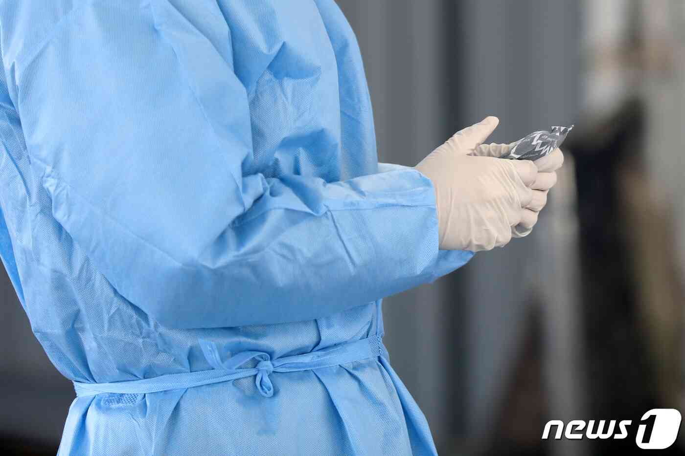 전국 대부분 지역에 한파경보와 한파주의보가 발표된 17일 오전 서울 중구 서울역광장에 마련된 신종 코로나바이러스 감염증(코로나19) 임시선별진료소에서 관계자가 핫팩으로 손을 녹이고 있다. 질병관리청 중앙방역대책본부는 이날 0시 기준 코로나19 신규 확진자가 1420명을 기록했다고 밝혔다. 황기선 기자