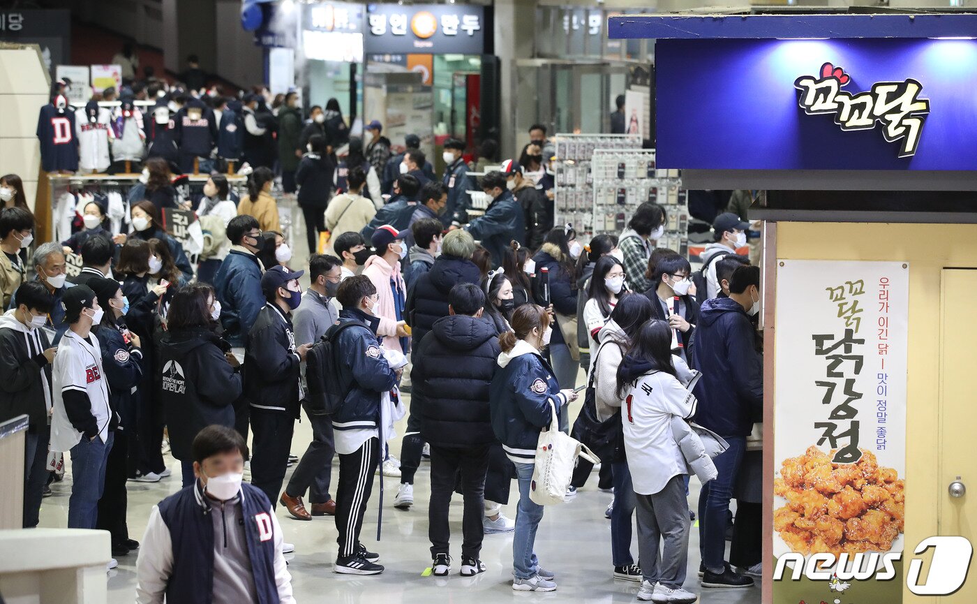 본문 이미지 - 1일 오후 서울 송파구 잠실야구장에서 열린 프로야구 '2021 신한은행 SOL KBO 포스트시즌‘ 와일드카드 결정전 1차전 키움 히어로즈와 두산 베어스의 경기에서 관중들이 치맥 구매하기 위해 줄지어 기다리고 있다. 이번 포스트시즌 전 경기는 '전 좌석 접종자 구역'으로 운영된다. 이에 따라 백신 2차 접종 후 2주가 경과한 백신 접종 완료자를 포함한 48시간 내 PCR 음성확인자, 18세 이하, 불가피한 사유의 접종 불가자(의사 소견서 필요)도 입장이 가능하다. 2021.11.1/뉴스1 ⓒ News1 임세영 기자