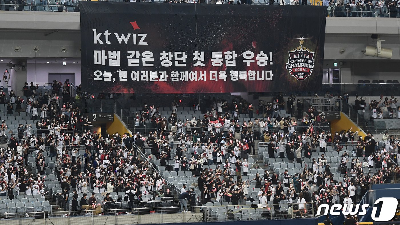본문 이미지 - 18일 오후 서울 구로구 고척스카이돔에서 열린 '2021 신한은행 쏠 KBO 한국시리즈’ 4차전 kt wiz와 두산 베어스의 경기에서 8대4로 승리해 한국시리즈 우승을 거머쥔 KT 1루 응원단에 대형 현수막이 나오고 있다. KT는 한국시리즈 4경기를 내리 이기며 창단 후 첫 우승 트로피를 들어올렸다. 2021.11.18/뉴스1 ⓒ News1 김진환 기자
