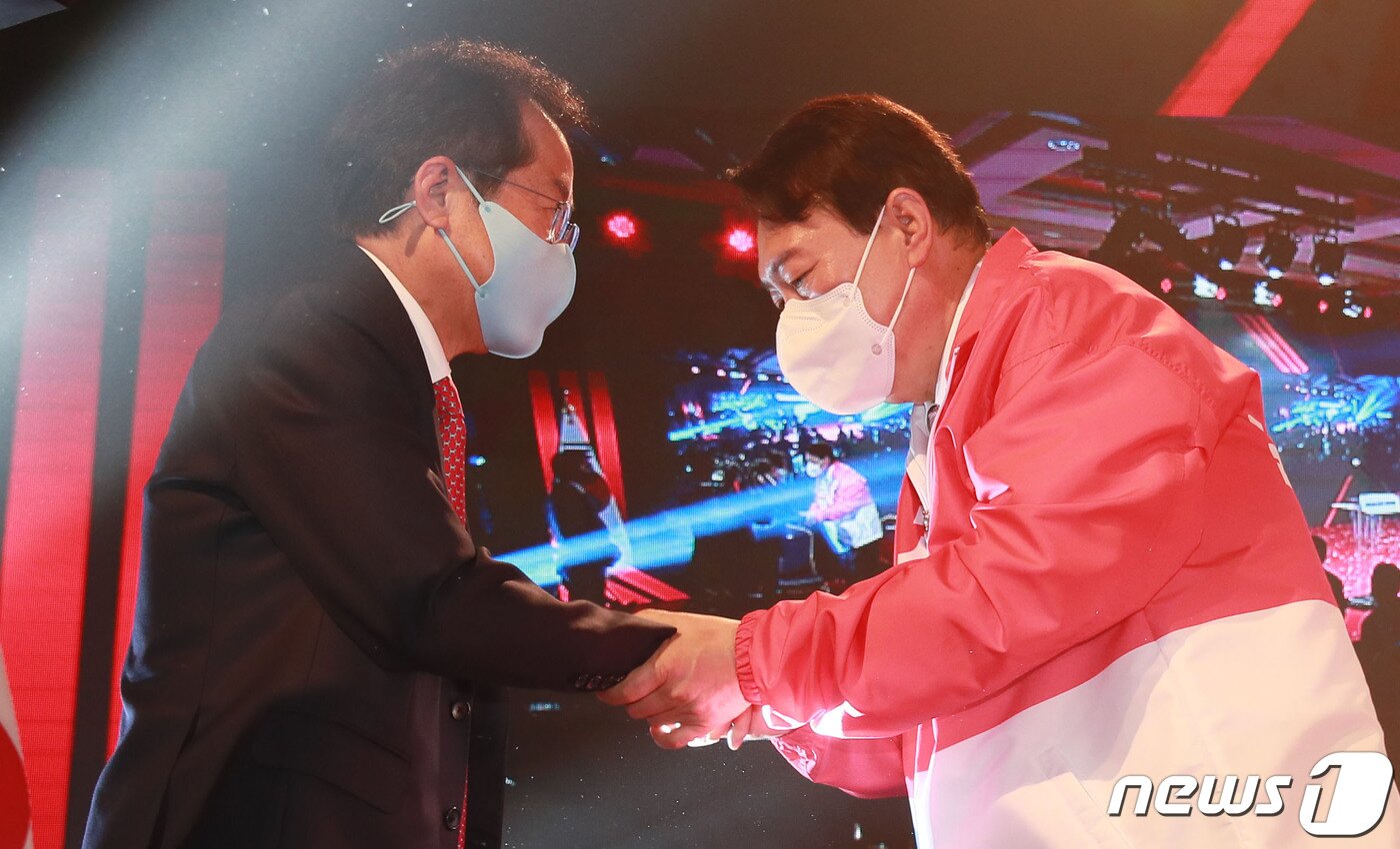 본문 이미지 - 윤석열 국민의힘 대선후보가 5일 서울 용산구 효창동 백범김구기념관에서 열린 제2차 전당대회에서 홍준표 후보와 악수하고 있다. 2021.11.5/뉴스1 ⓒ News1 오대일 기자
