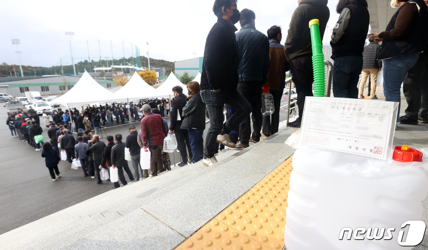 본문 이미지 - 9일 전북 익산시 실내체육관 앞에 마련된 요소수 판매장에서 요소수 구매를 위해 몰린 시민들이 길게 줄지어 차례를 기다리고 있다. 2021.11.9/뉴스1 ⓒ News1 유경석 기자