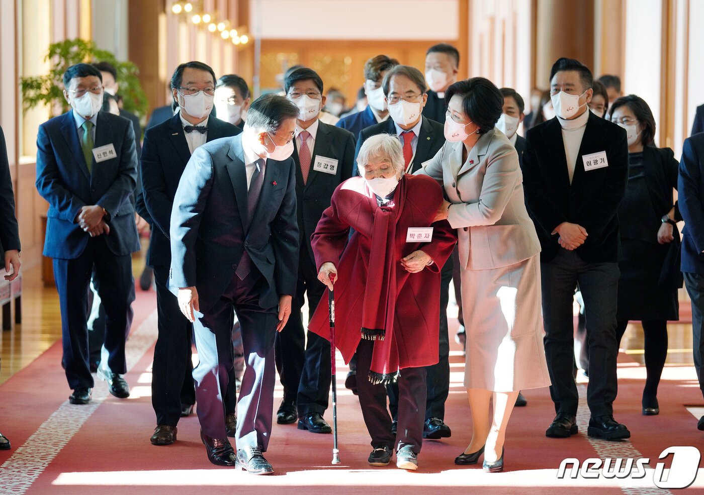 본문 이미지 - 문재인 대통령과 부인 김정숙 여사가 3일 청와대에서 열린 '2021 기부·나눔단체 초청행사'에서 성금전달을 마친 후 초록우산어린이재단 기부자 박춘자 할머니와 환담장으로 이동하고 있다. ⓒ News1