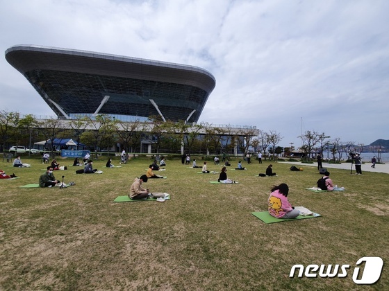 국립해양박물관 앞 정원에서 '海(해)멍海(해)몽 행사 참가자들이 앉아 바다를 보며 명상을 하고 있다.2021.4.21/© 뉴스1 손연우 기자