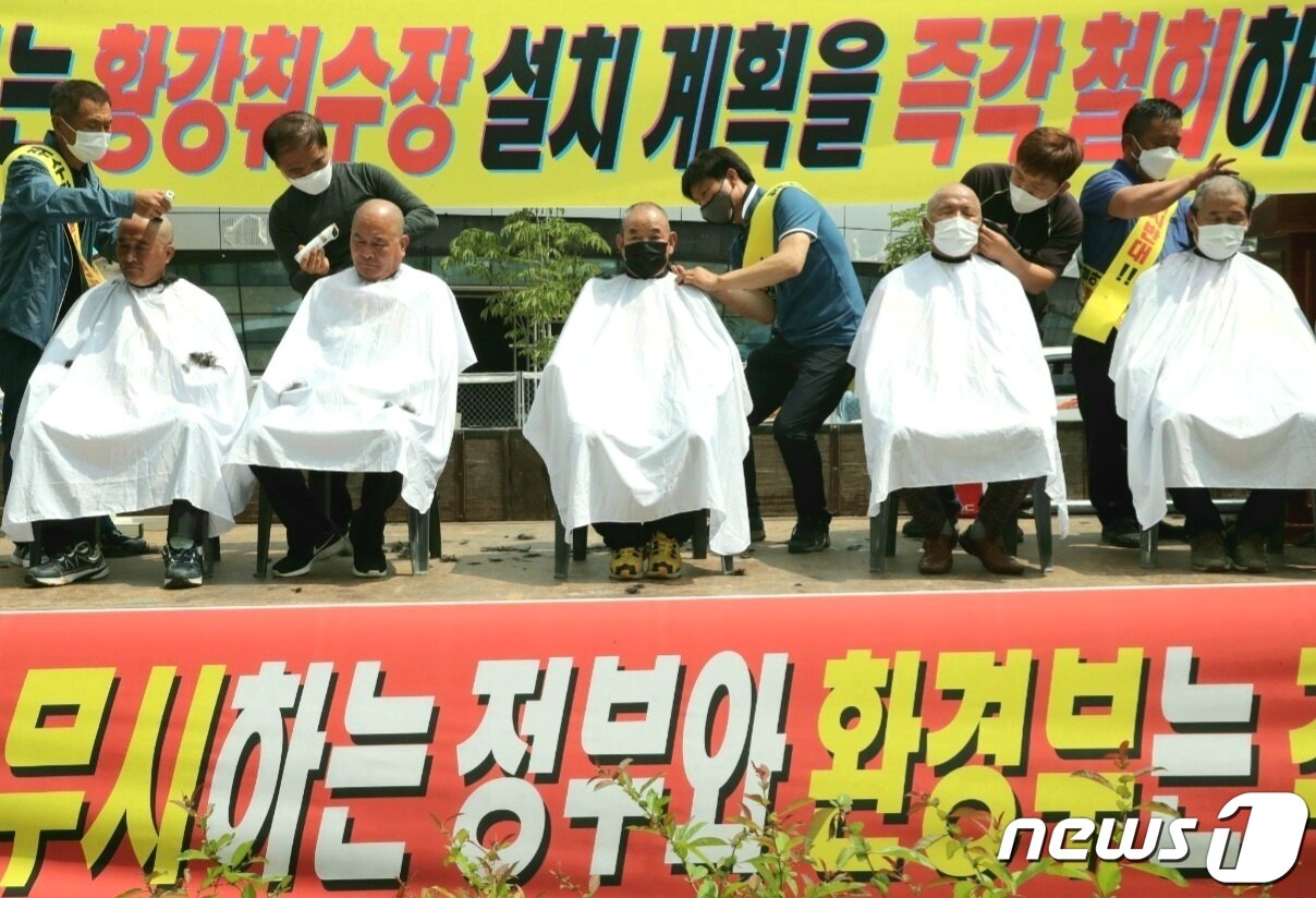 본문 이미지 - 합천·거창·창녕군의 주민들이 지난 24일 세종시 환경부 청사 입구에서 낙동강 통합 물관리 방안 심의에 반발하며 삭발을 하고 있다. (합천군 황강취수장 설치반대 군민대책위 제공) ⓒ 뉴스1