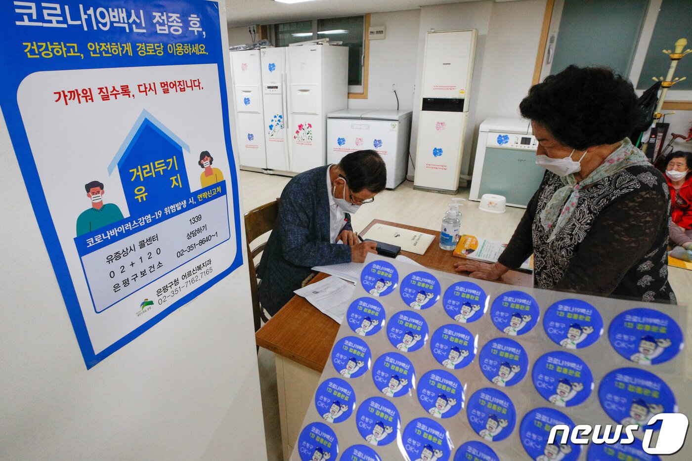 본문 이미지 - 7일 서울 은평구 충암경로당에서 관계자가 신종 코로나바이러스 감염증(코로나19) 백신 접종 증명 스티커를 배부하고 있다. 2021.6.7/뉴스1 ⓒ News1 안은나 기자