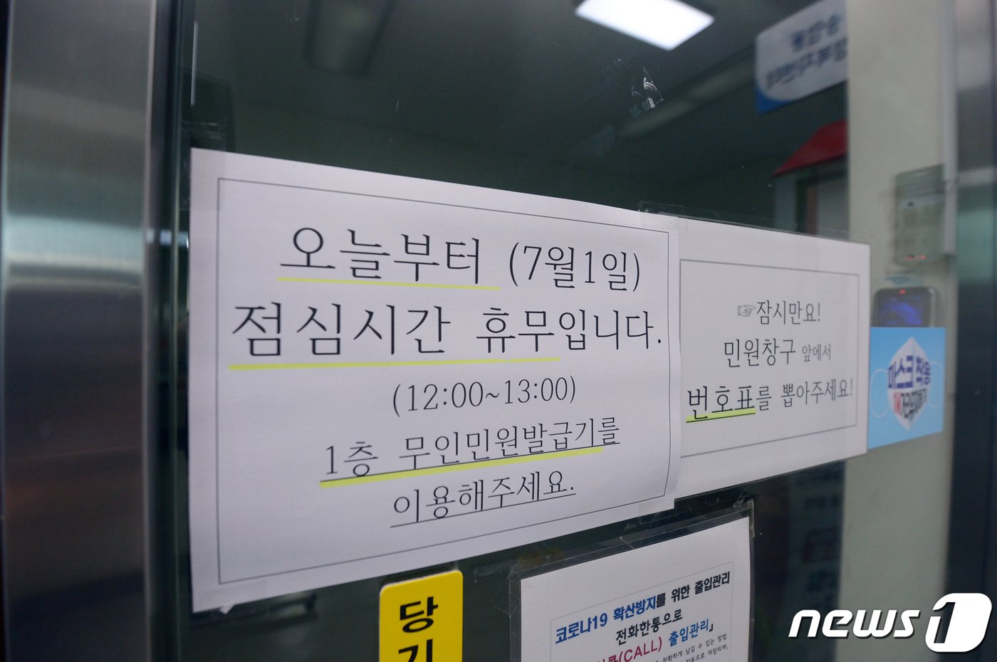 본문 이미지 - 낮 12시부터 오후 1시까지 민원 업무를 보지 않는 점심시간휴무제 시행 첫날인 1일 오전 광주 한 행정복지센터 출입문에 휴무제 시행을 알리는 공고문이 붙어 있다. 2(사진은 기사 내용과 무관함) 021.7.1/뉴스1 ⓒ News1 DB