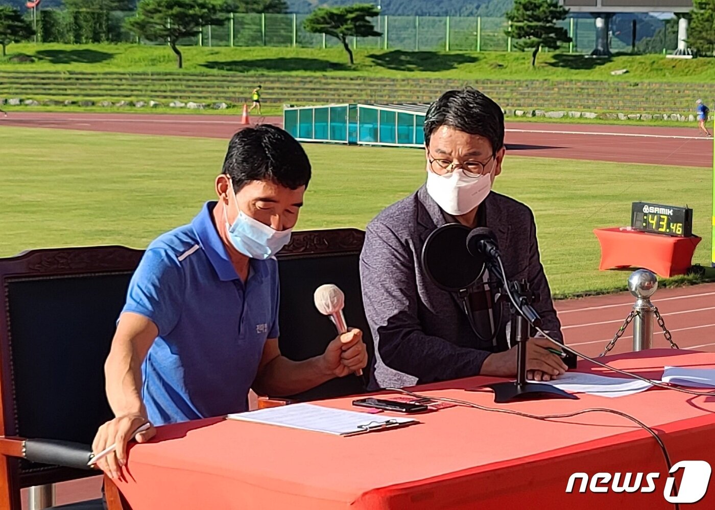 본문 이미지 - 김돈곤 청양군수가 7일 청양공설운동장에서 열린 메달 획득을 기원하는 10㎞ 단축 마라톤 중계석에서 오주한 선수에게 응원 메시지를 보내고 있다.ⓒ 뉴스1