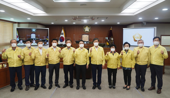 황명선 논산시장(왼쪽 여덟번째)과 논산시의회 의원들이 재난지원금 관련 원포인트 추경안을 의결하고 기념사진을 찍었다.(논산시 제공)© 뉴스1