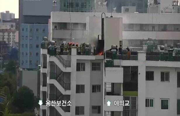 본문 이미지 - 소방대원들이 아파트 옥상에서 진화작업을 벌이고 있다. 경찰 CCTV 갈무리 ⓒ 뉴스1