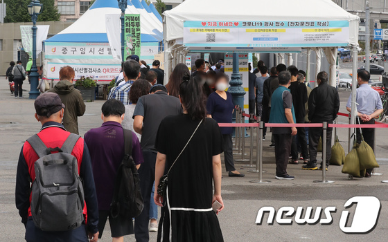 25일 서울 중구 서울역광장에 마련된 선별검사소에서 시민들이 코로나19 검사를 받기 위해 줄을 서서 기다리고 있다. /뉴스1 © News1 박세연 기자