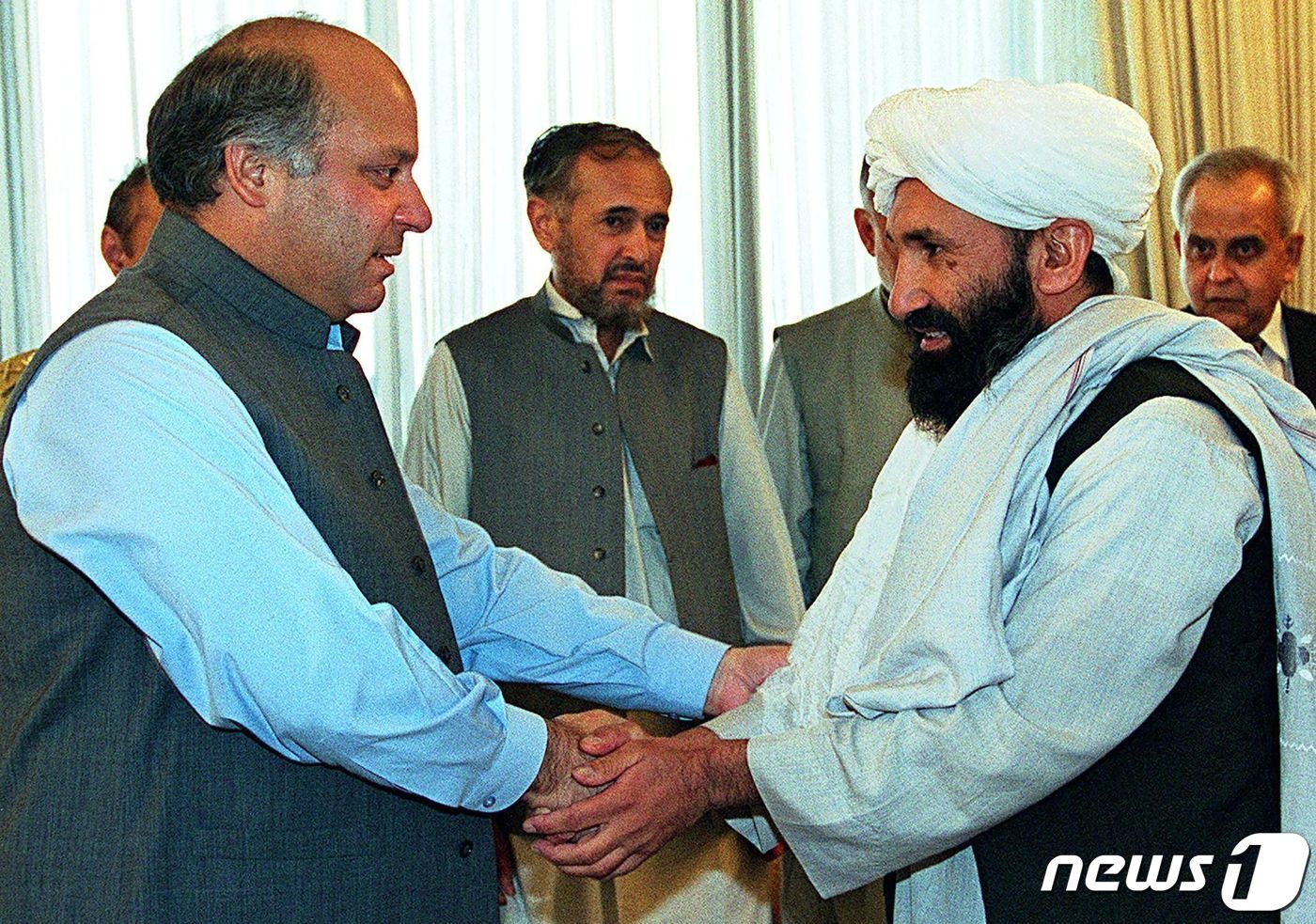 본문 이미지 - 1999년 아프가니스탄의 외무장관으로 재직할 당시의 물라 모하마드 하산 아쿤드(오른쪽). ⓒ AFP=뉴스1