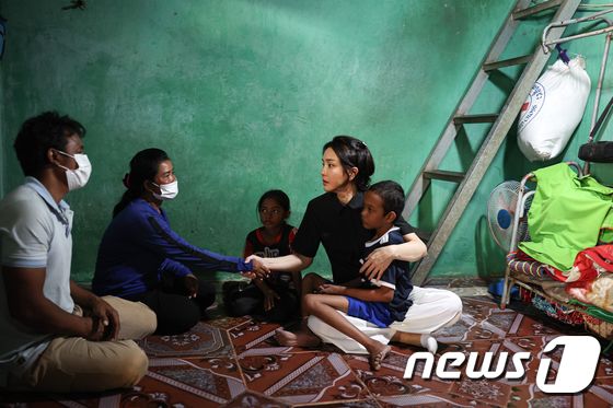 윤석열 대통령 부인 김건희 여사가 12일 캄보디아 프놈펜에서 선천성 심장질환을 앓고 있는 14세 아동의 집을 찾아 가족을 위로하고 있다. 대통령실에 따르면 이 아동의 어머니는 “12명의 자녀 중 가난으로 4명의 자녀를 잃었다