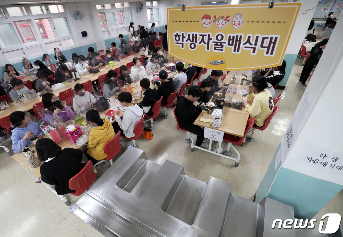 본문 이미지 - 전국학교비정규직연대회의가 총파업에 들어간 25일 울산 중구 태화초등학교 급식실에서 학생들이 점심으로 도시락을 먹고 있는 가운데 학생 자율배식대가 텅 비어 있다. 2022.11.25/뉴스1 ⓒ News1 윤일지 기자