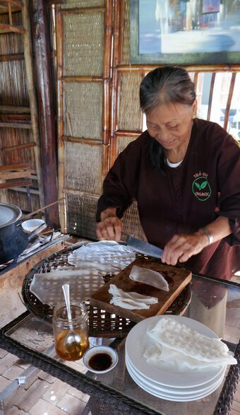 본문 이미지 - 넓은 쌀국수 면을 만들어 보여주는 농부의 가족(아내)ⓒ News1