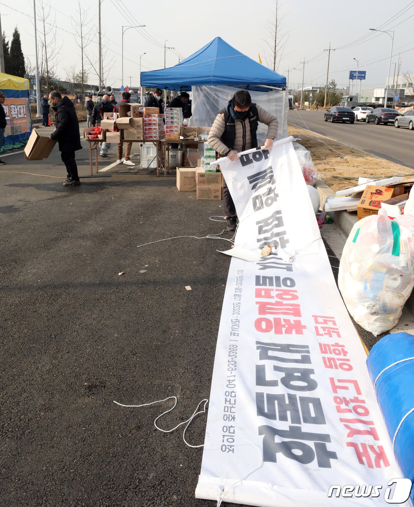 본문 이미지 - 9일 민주노총 공공운수 노조 화물연대 충남본부 조합원들이 파업철회 찬반투표 결과 파업종료로 가결 되면서 충남 당진시 현대글로비스 앞 파업 농성장을 철거하고 있다. 2022.12.9/뉴스1 ⓒ News1 김기남 기자