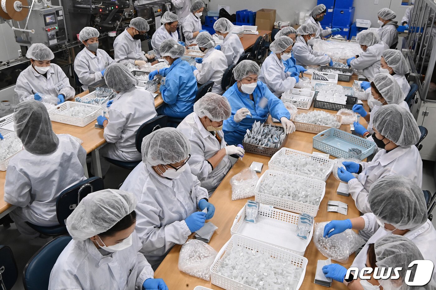 본문 이미지 - 최근 정부가 신종 코로나바이러스 감염증(코로나19) 오미크론 변이 확산에 따라 검사 체계를 전환하면서 자가검사키트의 수요가 급증한 가운데 9일 오후 경기도 군포시 휴마시스 군포공장에서 직원들이 코로나19 자가검사키트를 생산하고 있다. 2022.2.9/뉴스1 ⓒ News1 김영운 기자