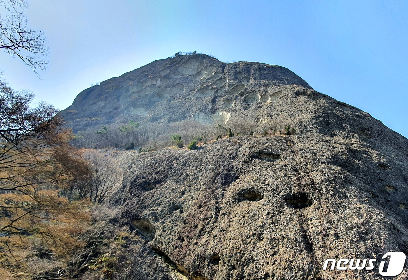 본문 이미지 - 암마이봉의 디테일. 1억년의 풍화작용으로 암석이 듬성듬성 뜯겨져 나간 자국(위)과 자갈이 빠져나가 구멍이 숭숭 뚫린 자국(아래) ⓒ 뉴스1