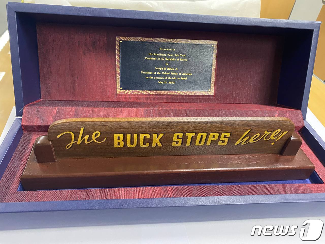 본문 이미지 - 조 바이든 미국 대통령이 2박 3일의 방한 일정을 마치며 윤석열 대통령에게 선물한 탁상 푯말. 해리 트루먼 전 대통령이 재임 시절 탁상에 비치했던 푯말과 동일한 것으로 'The Buck Stops Here!'라고 새겨져 있다. '대통령은 결정을 내리고 그 결과에 대한 책임을 지는 자리'라는 의미로 트루먼 대통령이 1953년 고별연설에서 인용한 문구다. (대통령실 제공) 2022.5.22/뉴스1 ⓒ News1 안은나 기자