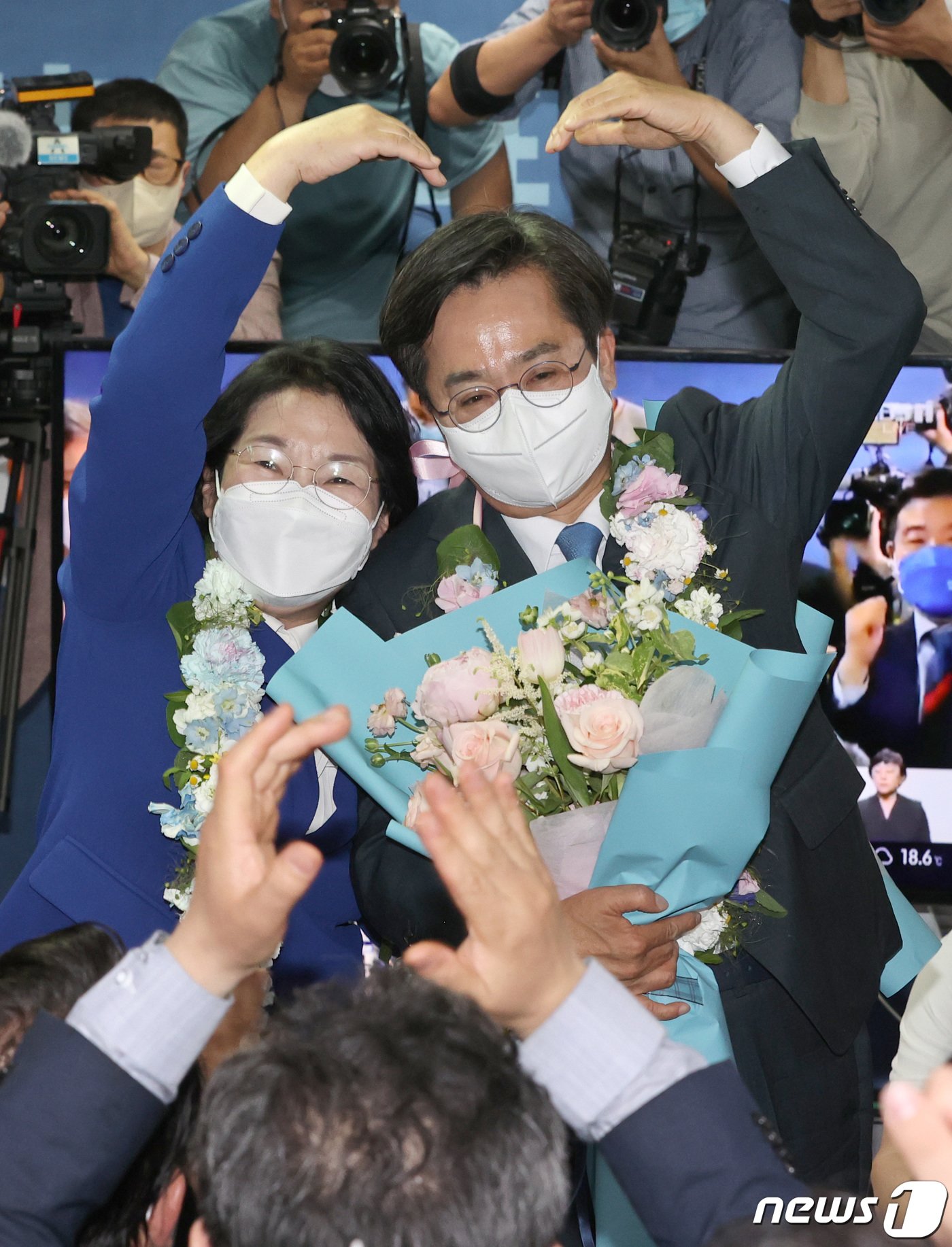 김동연 더불어민주당 경기도지사 후보 내외가 2일 오전 경기 수원시 팔달구 마라톤빌딩에 마련된 선거사무소에서 당선이 확실시 되자 지지자들을 향해 하트를 그리고 있다. 2022.6.2/뉴스1 ⓒ News1 경기사진공동취재단