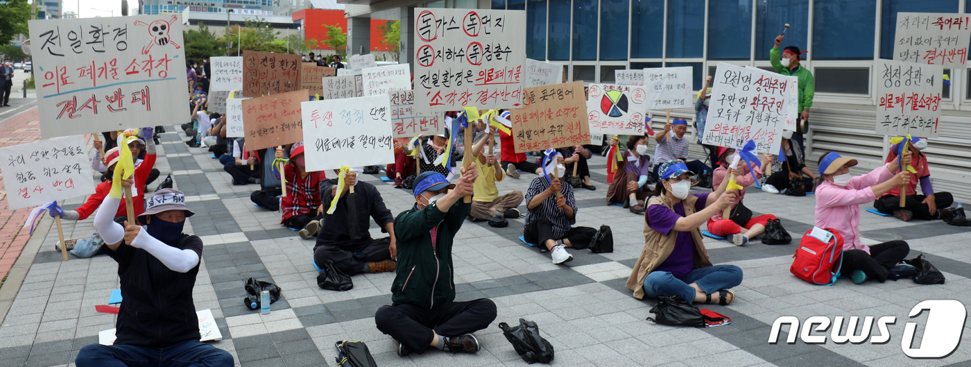 (전주=뉴스1) 유경석 기자 = 전일환경 의료폐기물 소각장 반대투쟁위원회 관계자들이 23일 전북 전주시 전북지방환경청 앞에서 가진 결의대회에서 구호를 외치고 있다. 2022.6.2 …