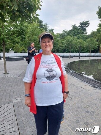 본문 이미지 - 한국전에 참전했다 실종된 오빠를 찾고 있는 쟌넷 셀버그. 오빠의 사진과 실종 장소 등이 적혀 있는 티셔츠를 입고 있다. ⓒ 뉴스1