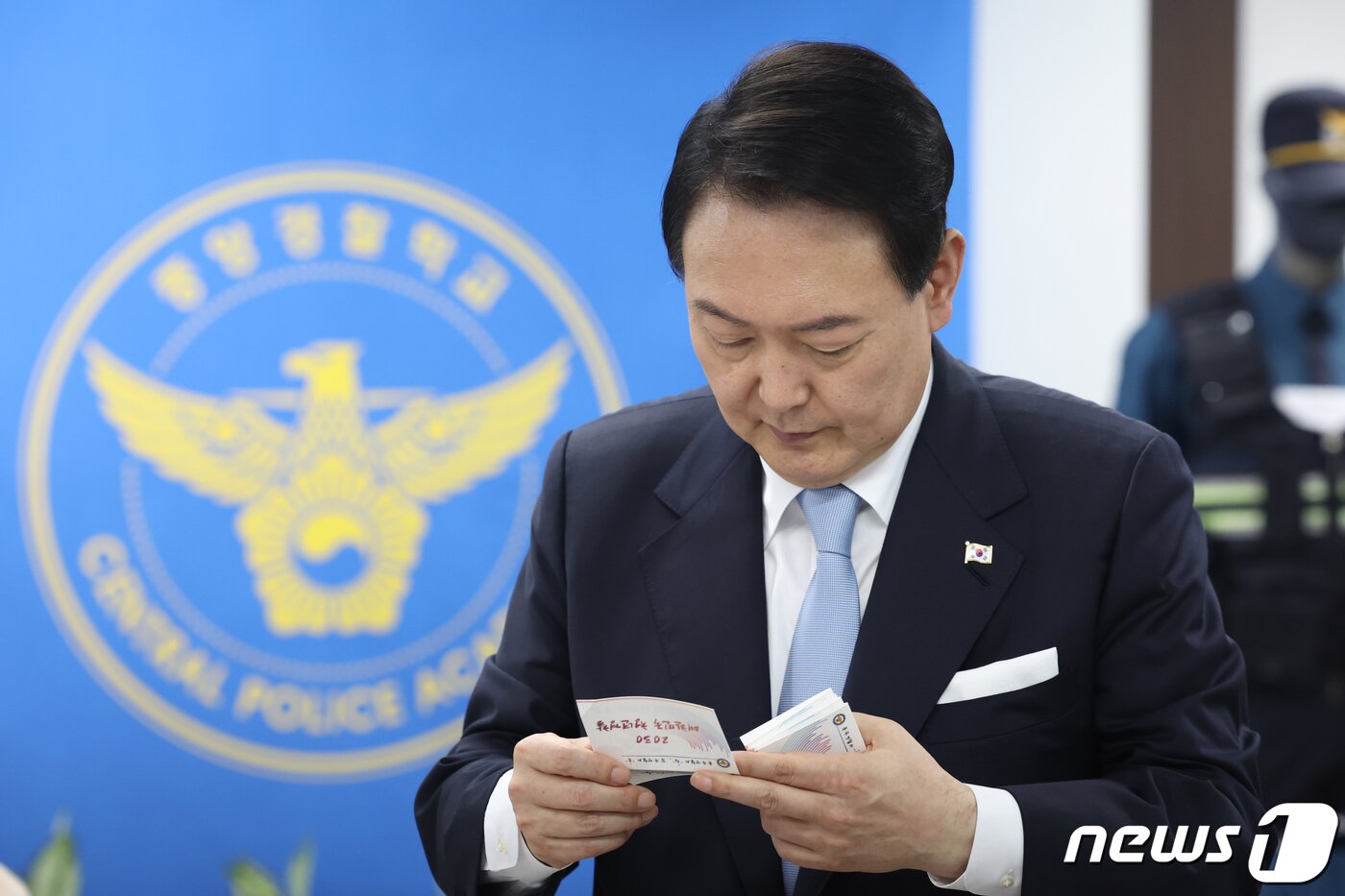 본문 이미지 - 윤석열 대통령이 19일 충북 충주 중앙경찰학교에서 열린 20·30 청년경찰관 간담회에서 청년 경찰관들의 소망이 적힌 쪽지를 읽고 있다. (대통령실 제공) 2022.8.19/뉴스1 ⓒ News1 오대일 기자