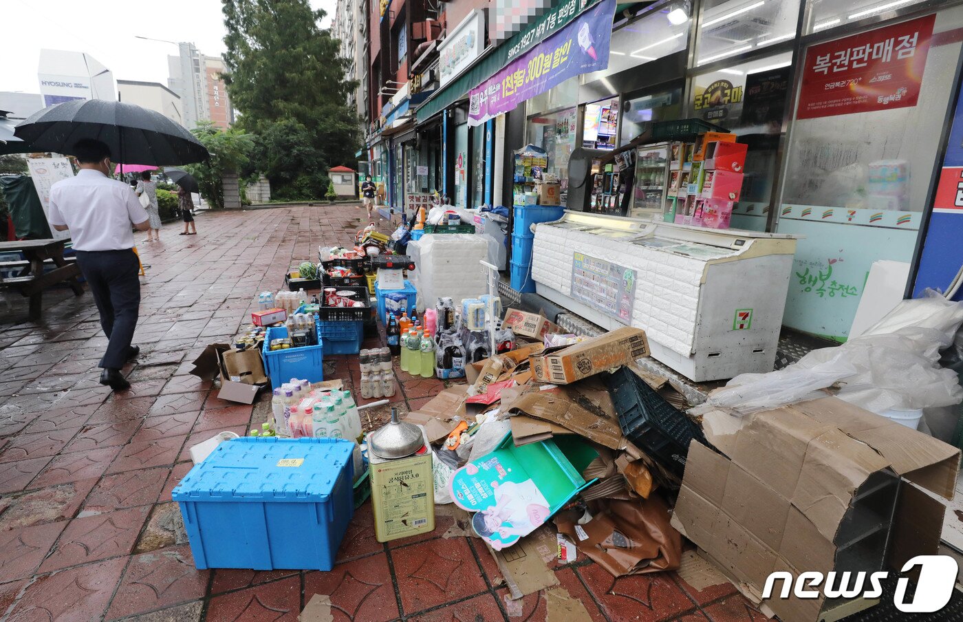 본문 이미지 - 서울을 비롯한 중부지역에 기록적인 폭우가 내린 9일 오전 서울 서초구 서초동 서초대로에 침수피해를 입은 편의점에서 침수된 물품을 꺼내 놓고 있다. 2022.8.9/뉴스1 ⓒ News1 박세연 기자