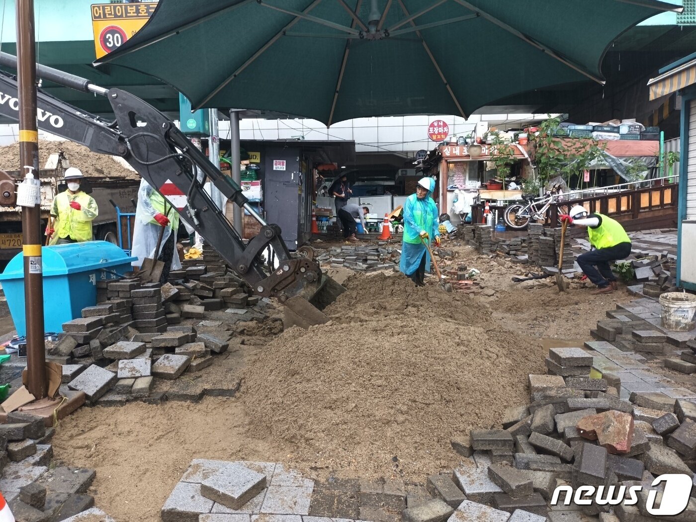 본문 이미지 - 9일 서울 관악구 조원동에 도림천이 범람하면서 곳곳이 침수 피해를 입었다.  사진은 보도블록 복구작업이 한창인 신대방역 앞 모습. ⓒ 뉴스1