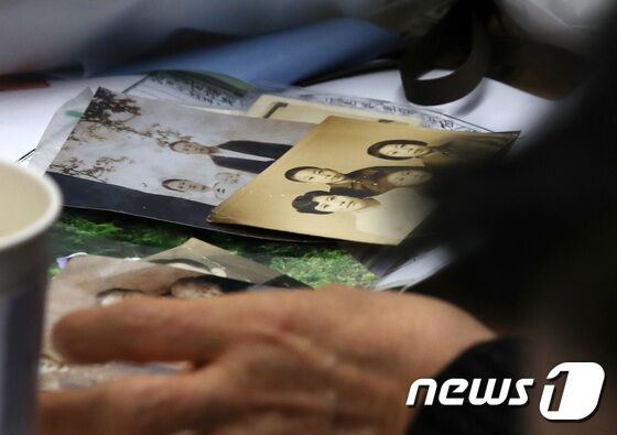 헤어진 뒤 서로 찾지 못하던 장기 실종 가족 장택훈, 장희재, 장경인, 장희란 남매가 31일 오후 서울 동작경찰서에서 58년 만에 다시 만나 가족사진을 보고 있다. 동작경찰서는 아동권리보장원과 함께 경찰 DNA 대조 등을 통해 지난 1965년 3월께 서울 노원구 태릉 부근에서 실종된 장 씨 가족 4남매 중 여동생 2명을 모두 찾아 이날 재회하는 자리를 마련했다. 2023.1.31/뉴스1 © News1 구윤성 기자