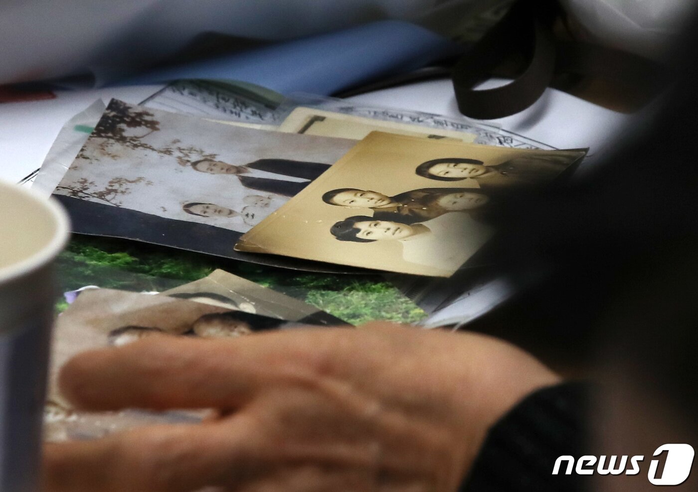 본문 이미지 - 헤어진 뒤 서로 찾지 못하던 장기 실종 가족 장택훈, 장희재, 장경인, 장희란 남매가 31일 오후 서울 동작경찰서에서 58년 만에 다시 만나 가족사진을 보고 있다. 동작경찰서는 아동권리보장원과 함께 경찰 DNA 대조 등을 통해 지난 1965년 3월께 서울 노원구 태릉 부근에서 실종된 장 씨 가족 4남매 중 여동생 2명을 모두 찾아 이날 재회하는 자리를 마련했다. 2023.1.31/뉴스1 ⓒ News1 구윤성 기자
