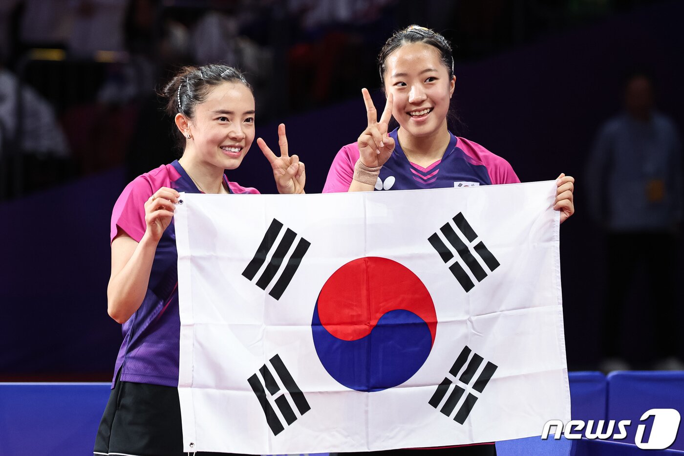 본문 이미지 - 신유빈-전지희가 2일 중국 항저우 궁수 캐널 스포츠파크 체육관에서 열린 2022 항저우 아시안게임 탁구 여자 복식 결승에서 금메달을 확정지은 후 태극기를 들고 포즈를 취하고 있다. 신유빈-전지희 조는 결승에서 북한 차수영-박수경 조를 게임 스코어 4-1(11-6 11-4 10-12 12-10 11-3)로 꺾고 금메달을 차지했다. 이는 2002년 부산 아시안게임 석은미-이은실 이후 21년 만의 아시안게임 여자 복식 금메달이다. 2023.10.2/뉴스1 ⓒ News1 유승관 기자