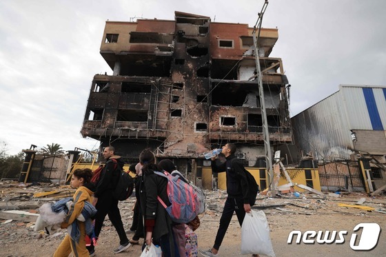 [사진] 포격 맞은 건물 앞 피난하는 가자 지구 주민들