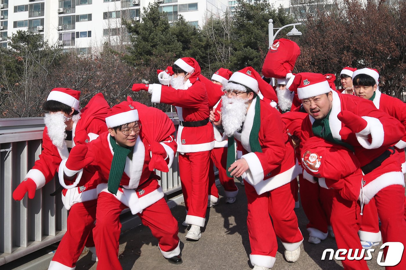 본문 이미지 - 크리스마스를 하루 앞둔 24일 대구 달서구 성서육교에서 '사랑의 새마을 몰래산타 대작전'에 참여한 산타들이 선물 꾸러미를 메고 소외된 이웃을 찾아 나서고 있다. 2023.12.24/뉴스1 ⓒ News1 공정식 기자