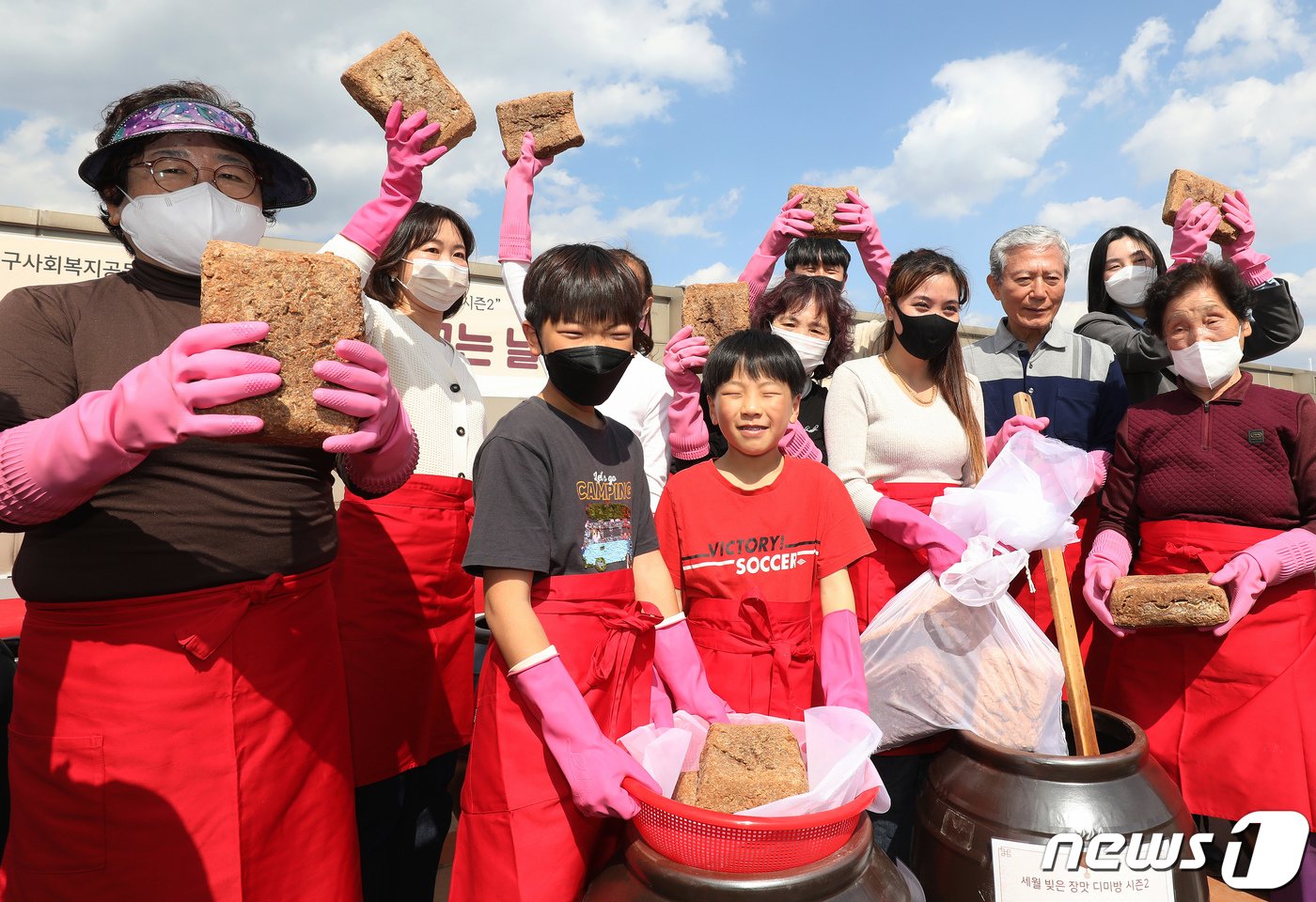 15일 오후 대구 달서구노인종합복지관 옥상에서 열린 &#39;달서구 온&#40;溫&#41;가족 장&#40;醬&#41; 담그는 날&#39; 행사에 참여한 어르신과 어린이, 다문화가족 등 마을주민들이 장독대에 모여 장을 담그고 있다. 2023.3.15/뉴스1 ⓒ News1 공정식 기자