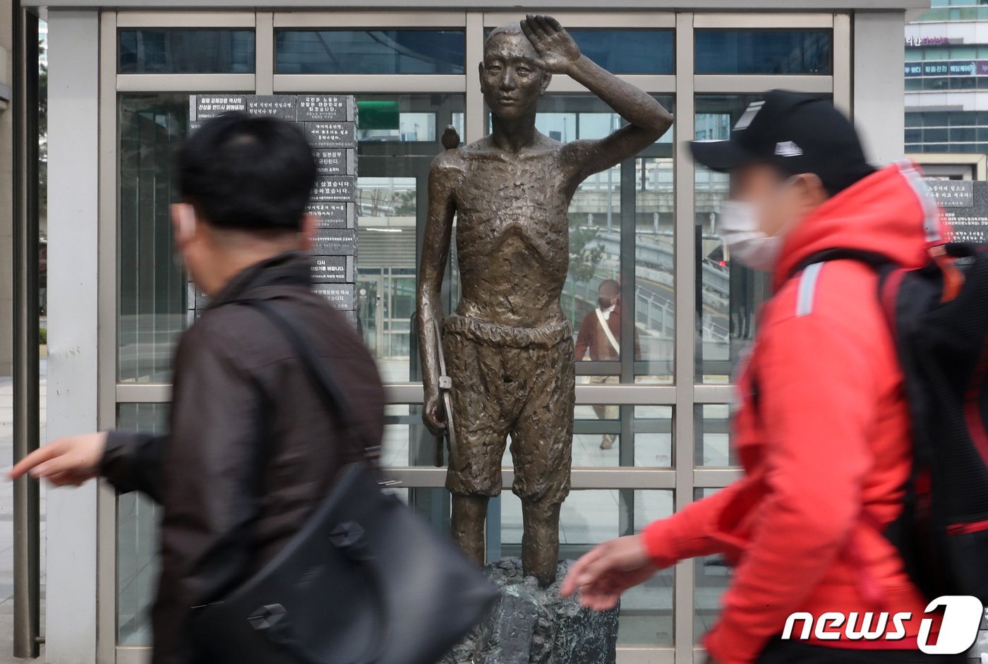 일본 초등학생이 내년도부터 사용할 사회 교과서에서 일제강점기 조선인 징병에 관한 기술이 강제성을 희석하는 방향으로 변경 발표된 28일 서울 용산구 용산역광장에 자리한 강제징용노동자상 앞으로 시민이 지나고 있다. 2023.3.28/뉴스1 ⓒ News1 이동해 기자