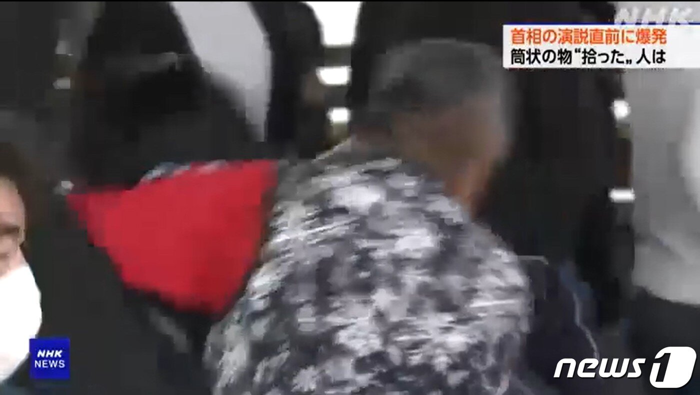 본문 이미지 - 15일 일본 혼슈 남쪽 와카야마현 와카야마시 사이카자키 항구에서 중의원 와카야마 1구 보궐선거 지원에 나선 기시다 후미오 총리를 향해 폭탄 투척 사건이 발생한 가운데 한 남성이 용의자에게 헤드록을 걸고 있다. NHK 화면 캡처