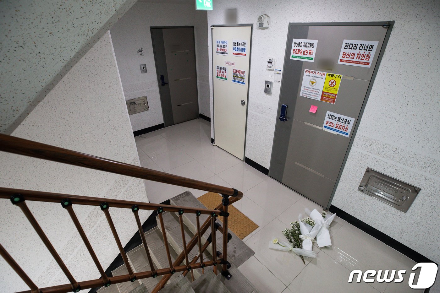 본문 이미지 - 20일 전세 사기 피해자들이 속출한 인천시내 한 아파트에 전세사기 피해로 극단적인 선택을 한 희생자를 추모하는 국화가 놓여 있다. 국민의힘과 정부는 20일 전세사기 피해와 관련해 피해 주택 경매시 일정 기준의 임차인에게 우선 매수권을 부여할 수 있도록 제도적 보완책을 마련하기로 했다. 또, 피해자들의 주거 안정을 위해 전 금융권의 경매공매 유예를 신속히 추진하겠다고 밝혔다. 2023.4.20/뉴스1 ⓒ News1 유승관 기자