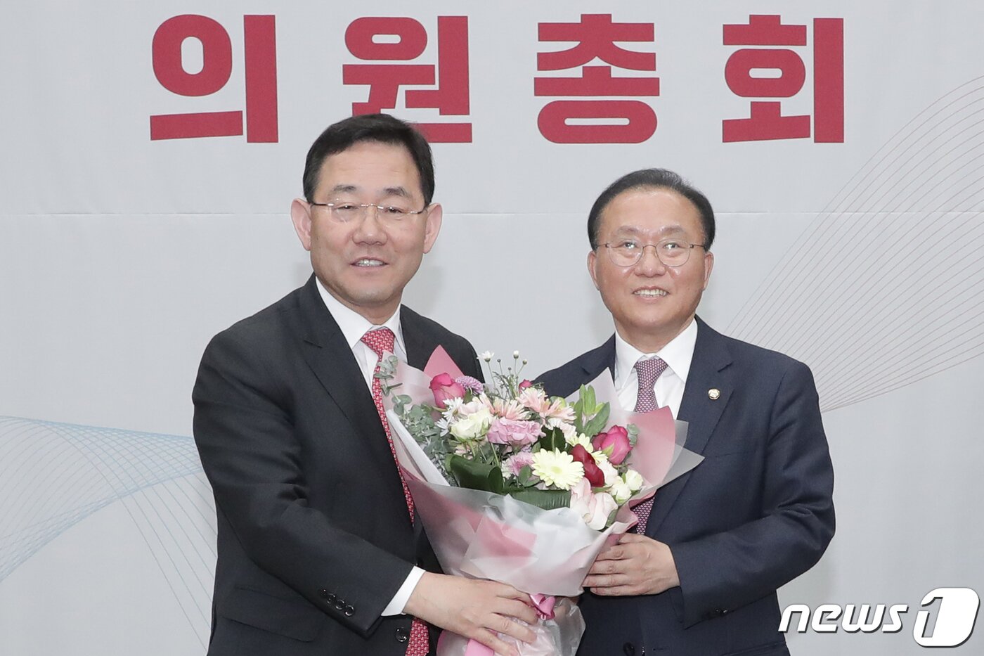 본문 이미지 - 윤재옥 신임 국민의힘 원내대표가 7일 서울 여의도 국회에서 열린 '2023 원내대표 선출 의원총회'에서 임기를 마친 주호영 국민의힘 원내대표로 부터 꽃다발을 받고 있다. (공동취재) 2023.4.7/뉴스1 ⓒ News1 황기선 기자