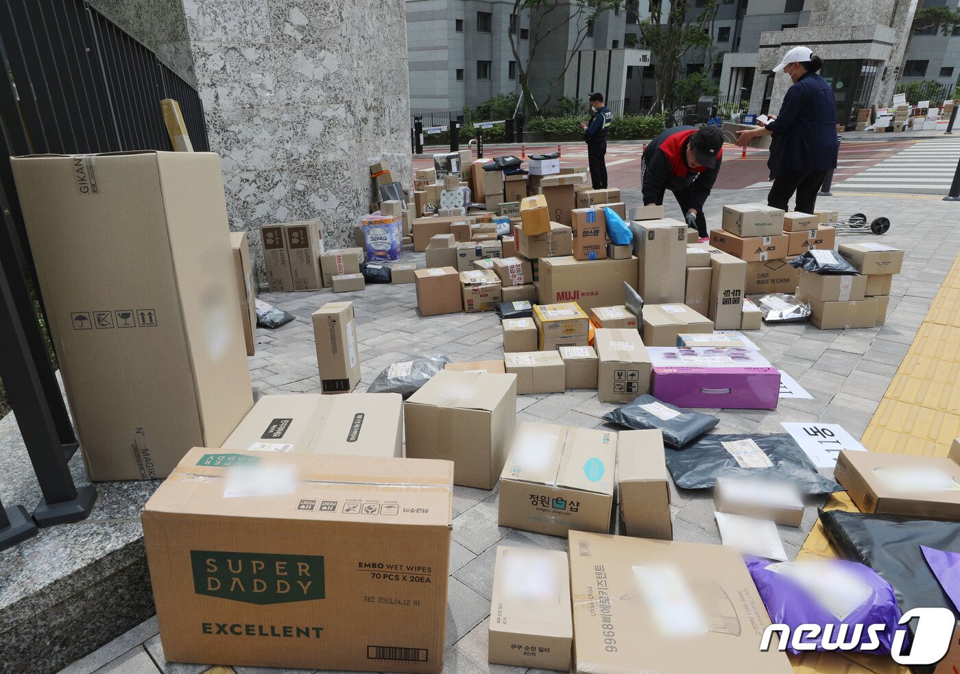 본문 이미지 - 10일 오후 경기 수원시의 한 대단지 아파트 정문에 택배들이 쌓여있다. 해당 아파트는 지난 1일부터 택배 차량의 지상 통행을 전면 금지하면서 택배 기사들이 문 앞까지 전달하던 택배 물건을 아파트 정문에 쌓아놓고 있다. 2023.5.10/뉴스1 ⓒ News1 김영운 기자