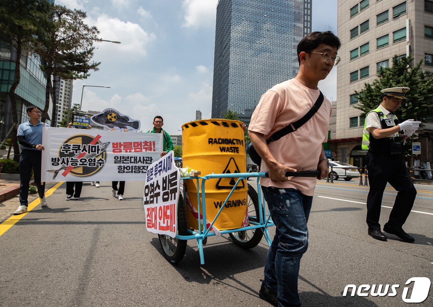 일본 방사성 오염수 해양투기저지서울행동 회원들이 15일 서울 서대문역에서 열린 일본 후쿠시마 오염수 방류 중단 항의 기자회견에서 방사능 드럼통을 운반하는 퍼포먼스를 하며 일본 대사관으로 행진하고 있다. 2023.6.15/뉴스1 ⓒ News1 이재명 기자