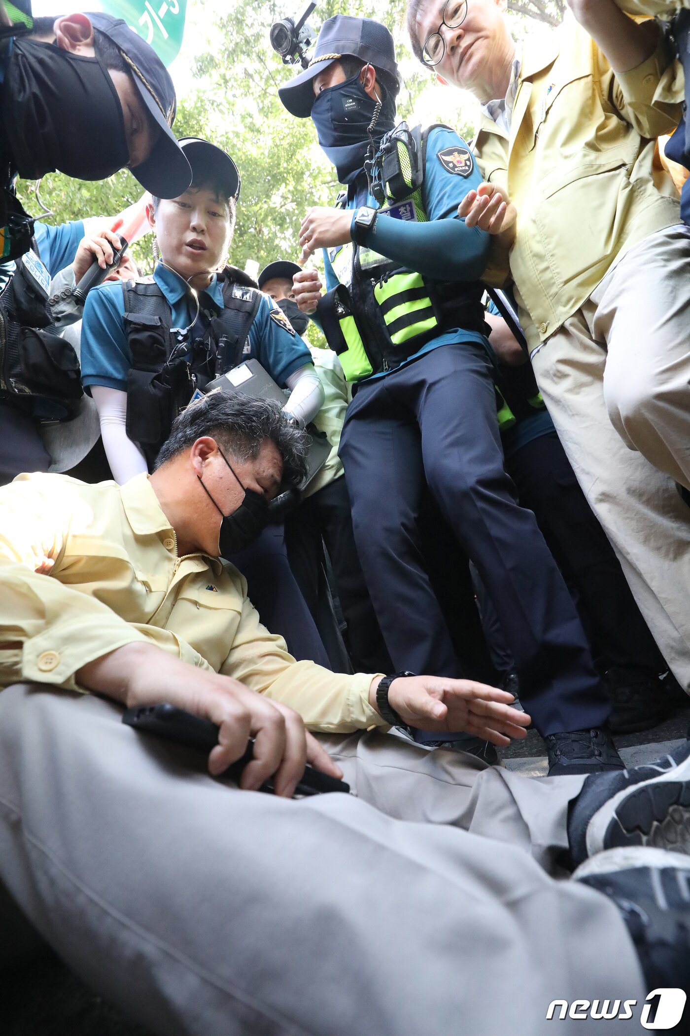 본문 이미지 - 17일 오전 대구 중구 중앙로 대중교통전용지구에서 열리는 제15회 대구퀴어문화축제를 앞두고 행정대집행에 나선 공무원들이 행사 차량의 진입을 막으려 하자 경찰이 이들을 해산시키는 과정에서 한 공무원이 도로에 넘어졌다 발목 등에 고통을 호소하며 주저앉아 있다. 2023.6.17/뉴스1 ⓒ News1 공정식 기자