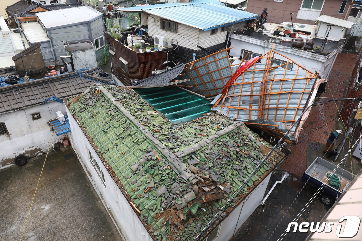 11일 오후 대구 도심에 기습적인 폭우가 쏟아진 가운데 중구 남산동의 한 주택 지붕이 크게 파손된 채 옆집에 걸쳐 있다. 2023.7.11/뉴스1 ⓒ News1 공정식 기자