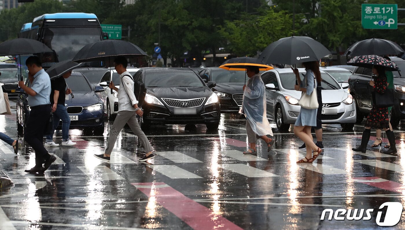 본문 이미지 - 집중호우가 내린 11일 서울 종로구 광화문역 인근에서 시민들이 우산을 쓰고 횡단보도를 건너고 있다. 2023.7.11/뉴스1 ⓒ News1 김민지 기자