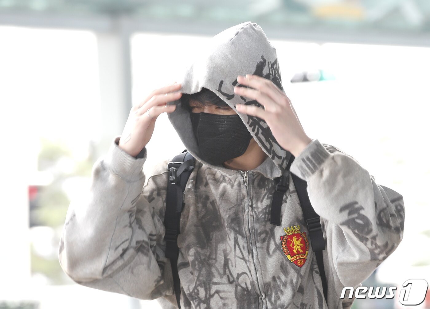 본문 이미지 - 방탄소년단(BTS) 정국이 해외 일정을 위해 12일 인천국제공항에 도착해 미국 뉴욕으로 출국하며 밀려오는 잠을 뿌리치고 있다.  ⓒ News1 권현진 기자