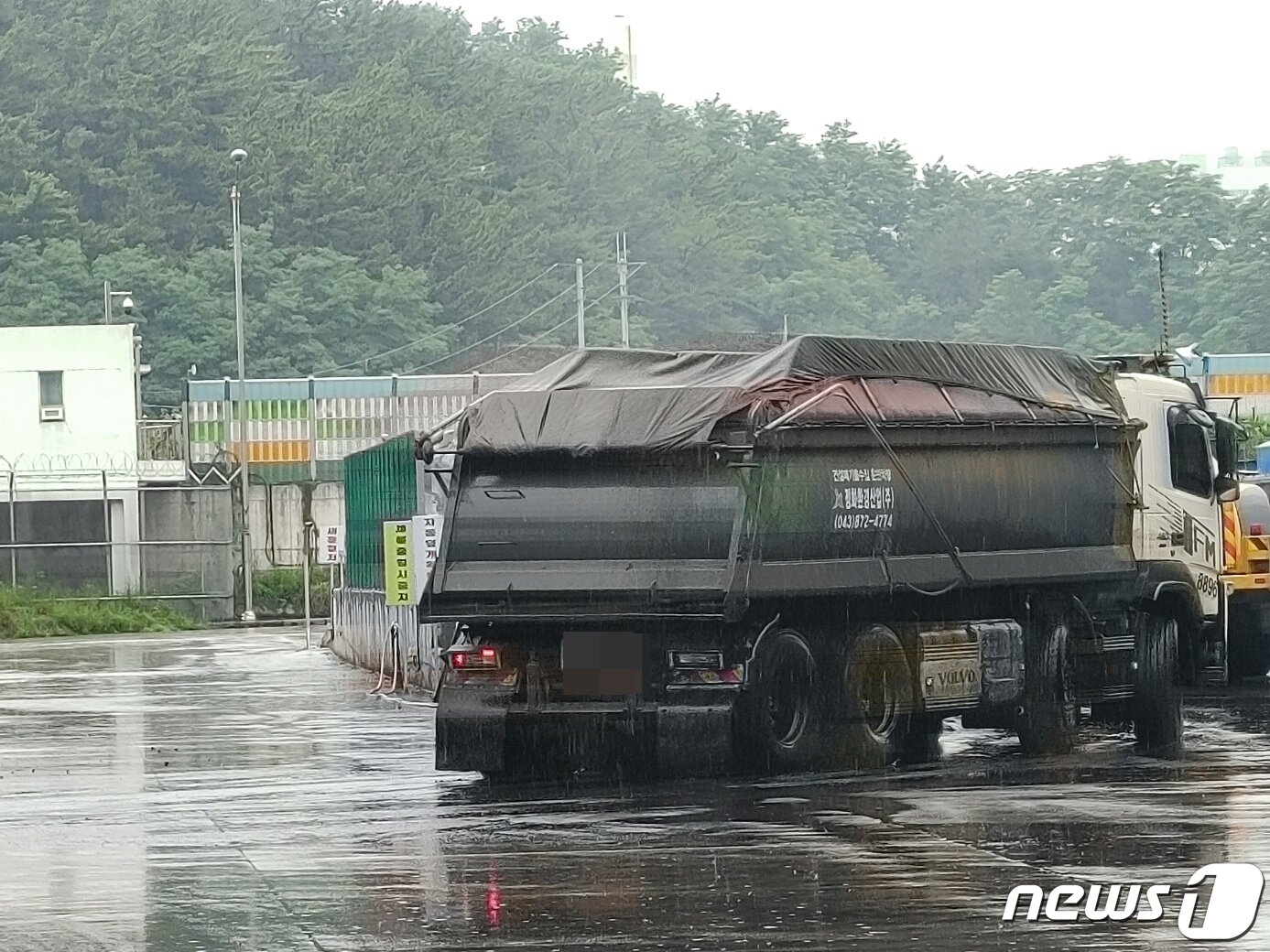 본문 이미지 - 삼척화력발전소에 사용될 석탄 육상운송이 시작된 18일 석탄을 실은 25톤 차량이 강원 동해시 동해항 석탄 하역부두를 빠져나가고 있다. 2023.7.18/뉴스1
